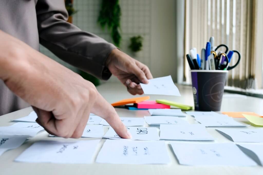 hands working with sticky notes
